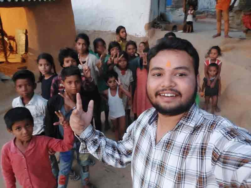 ताराचंडी धाम की आदिवासी बस्ती में जरूरतमंदों के साथ खुशियाँ साझा करते राज कमल जी